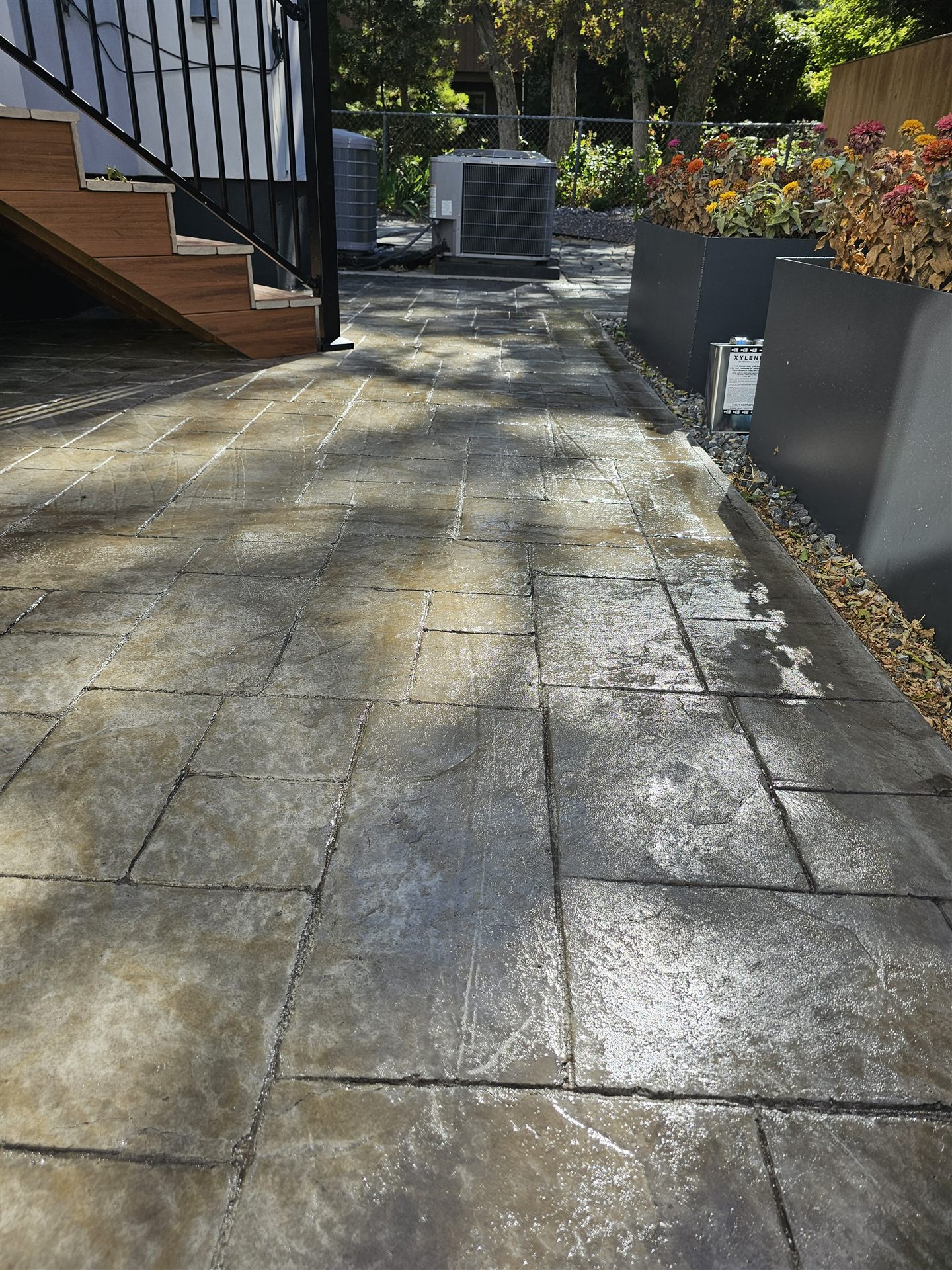 Freshly sealed flagstone-pattern stamped concrete patio and steps